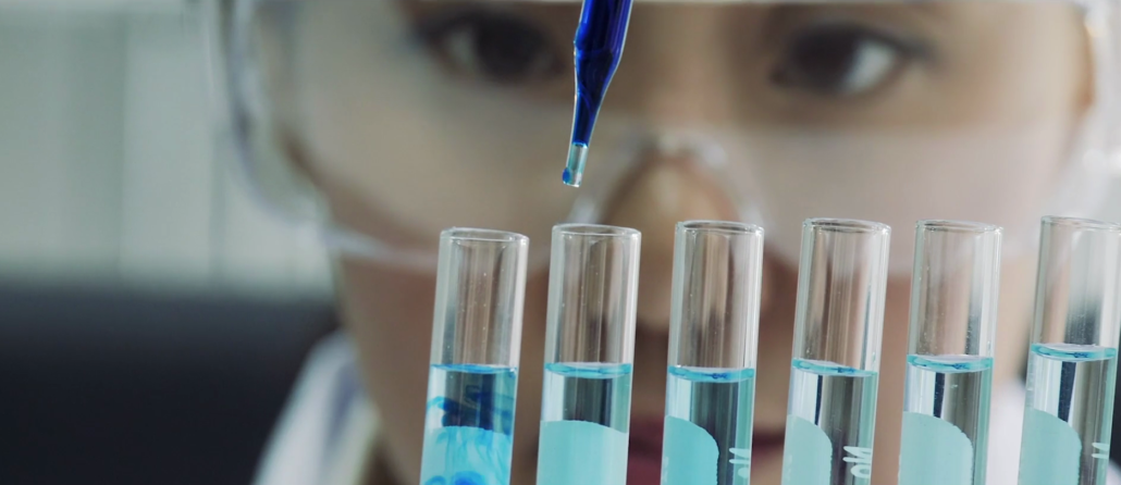 Researcher testing liquids in vials with a dropper for research of the brain.