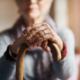 Elderly woman holding cane