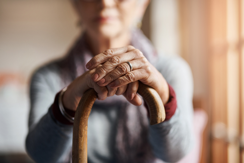 Elderly woman holding cane