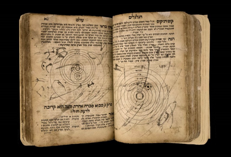 An open book with Hebrew text.