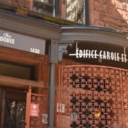 The outside of a red brick building with a sign that says "Chez Doris".